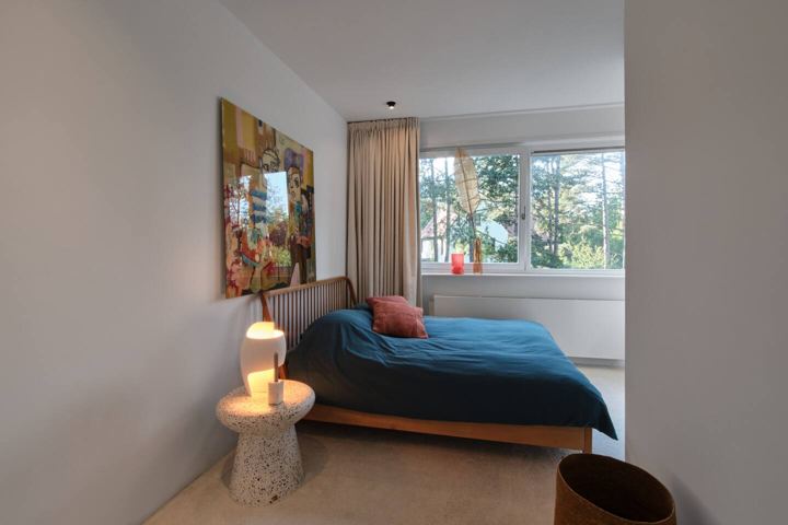 Schlafzimmer mit Doppelbett und Gartenblick